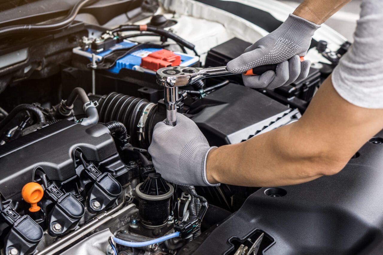 mechanic-man-working-on-the-engine-of-the-car-in-the-garage-car-service-and-maintenance-.jpg