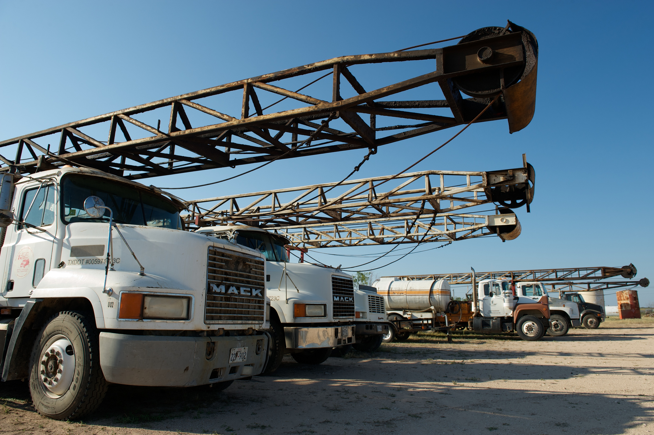 San Angelo, US - July 15 2012: Oil and gas industry truck-mounted drilling rigs on drilling rig trucks, near San Angelo, West Texas, US